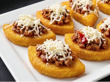 Corn "tortilla" topped with sausage and artisan cheese